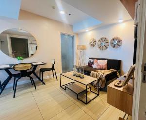 a living room with a couch and a table at The Bahamas & Maldives Suites at Azure Residences near Manila Airport in Manila