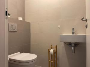 a bathroom with a toilet and a sink at SAG Sky park castle wiev Free parking Free wifi in Bratislava +9 photos