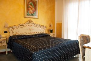 Postel nebo postele na pokoji v ubytování Hotel Confine