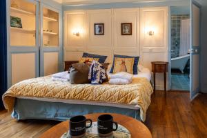 a bedroom with a bed with pillows on it at Château Hôtel Du Colombier in Saint Malo