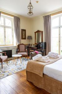 Katil atau katil-katil dalam bilik di Château Hôtel Du Colombier