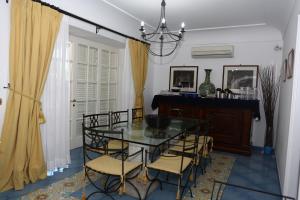 a dining room with a glass table and chairs at La Cicas in Anacapri