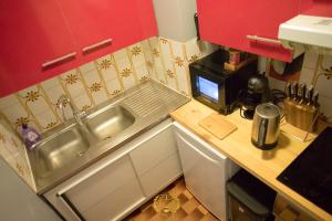 a small kitchen with a sink and a microwave at l'Or dans la Mer Partner in Nice