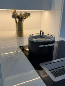 a pot sitting on top of a counter in a kitchen at Luxury Pearl Porto Peramos in Néa Péramos
