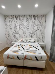 a bedroom with a white bed and a black and white wall at Grand Apartment Piran in Piran +49 photos