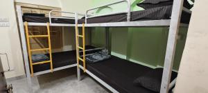 a room with three bunk beds in a room at Suitcase Stories in Kolkata +18 photos