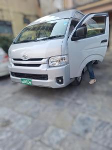 a model of a white van parked on a street at Sedan cab car four wheel jeep in Pokhara