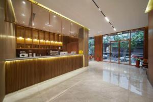 a lobby with a bar in a building at Le Chao Select Hotel in Shanghai