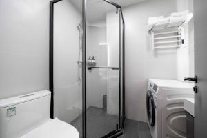 a bathroom with a toilet and a glass shower at Le Chao Select Hotel in Shanghai