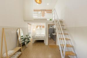 a living room with a staircase and a bathroom at Kim Quý Home in Phu Quoc