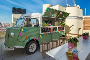 a green food truck parked on top of a building at Vincci The Mint in Madrid