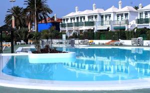 ein großer Pool mit blauem Wasser in einem Resort in der Unterkunft Paradise Tropical Sun Maspalomas in San Bartolomé de Tirajana