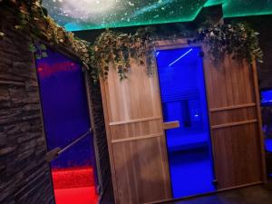 two doors in a room with blue and red lights at Majestic Wellness Center in Brussels
