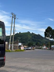 a bus is parked on the side of a street at Wilson Homes in Masaka