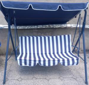 a blue and white bench sitting under a table at Guli in Gori
