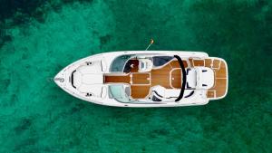 a white boat floating in the water in the ocean at Mallorcainblue Charter in Port d'Alcudia
