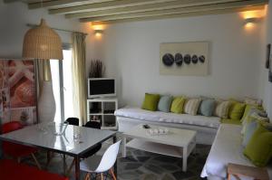 a living room with a couch and a table at Sea Side Studios & Houses in Kalo Livadi