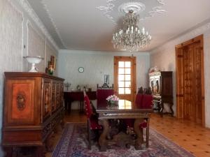 a living room with a chandelier and a dining room at Guli in Gori