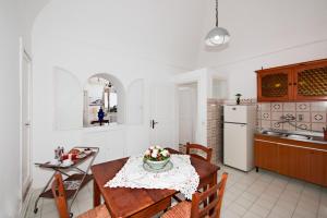 a kitchen with a table with a cake on it at Villa Setteventi in Positano