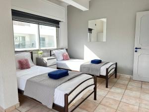 a room with two beds and a mirror at Adonis Holiday Apt - Nicosia in Nicosia