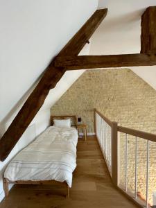 a bedroom with a bed in the attic at Peaceful countryside loft in Saonnet