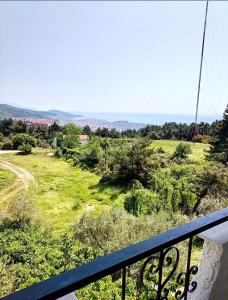 a view of a green field from a balcony at Philoxenia in Kavála