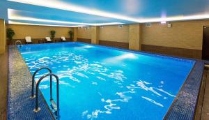 a large swimming pool in a hotel room at President Hotel in Ufa