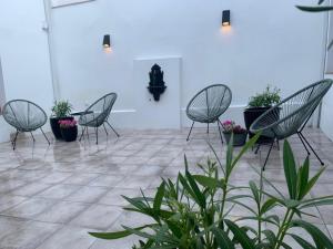 a group of chairs and potted plants in a room at La Rinconada de Perales in Perales de Tajuña