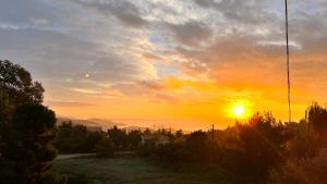 a sunset with the sun setting in the sky at Philoxenia in Kavála