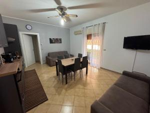 a living room with a table and a couch at Naxos Sweet Dreams Apartment in Giardini Naxos
