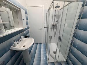 a bathroom with a sink and a shower at Naxos Sweet Dreams Apartment in Giardini Naxos +20 photos