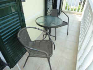 two chairs and a table on a balcony at diakopto free in Mesochórion