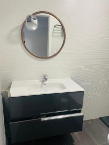 a bathroom with a sink and a mirror on the wall at Villa Neo - Private Pool - 8 minutes Corralejo, mini Gym!! in Villaverde
