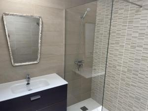 a bathroom with a sink and a glass shower at Villa Neo - Private Pool - 8 minutes Corralejo, mini Gym!! in Villaverde +22 photos