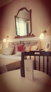 a bedroom with a bed with a mirror on the wall at B&B Abbacò in Palermo