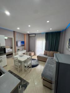 a kitchen and living room with a table and a couch at Flower Apartment Golem in Golem