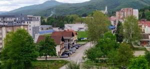 a city street in a town with mountains in the background at Apartman Bonaca in Kiseljak