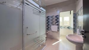 a bathroom with a glass shower and a sink at Star Vysta pyramids hotel in Cairo +121 photos