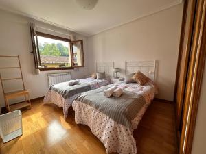 a bedroom with two beds and a window at Xorroxin in Elizondo