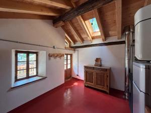 an empty kitchen with a refrigerator and a window at Riverside Rooms Emma For young and wild spirits in Pontboset