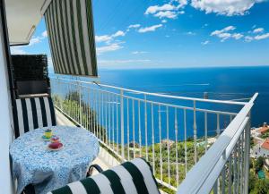 a balcony with a table and a view of the ocean at Luisa apartments, Coastal escape on the Amalfi Coast! in Furore