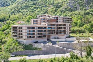 an apartment building in the middle of a mountain at LucaSa Apartment in Kotor