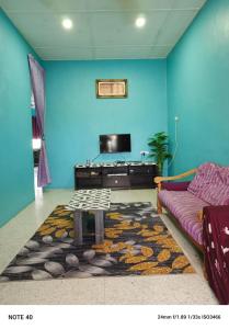 a living room with a couch and a table at Hazaff Homestay in Sungai Petani +5 photos