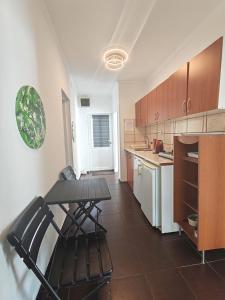 a kitchen with a table and chairs in it at Guest House Lara in Neum