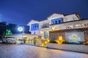 a house with a car parked in front of it at The Fountain Çeşme in Çeşme