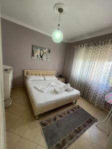 a small bedroom with a bed and a light at Flower Apartment Golem in Golem