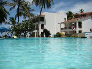 a swimming pool in front of a building at Nyali Beach Holiday Resort in Nyali