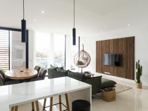Una sala de estar con una mesa y sillas y un televisor. en Oriental, en Mindelo