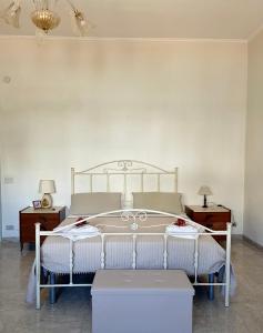 a bedroom with a white bed and two night stands at Maison Le Calle B&b in San Giorgio Ionico +17 photos