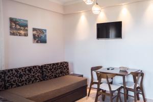 a living room with a couch and a table at Liogerma Apartments in Pefkochori